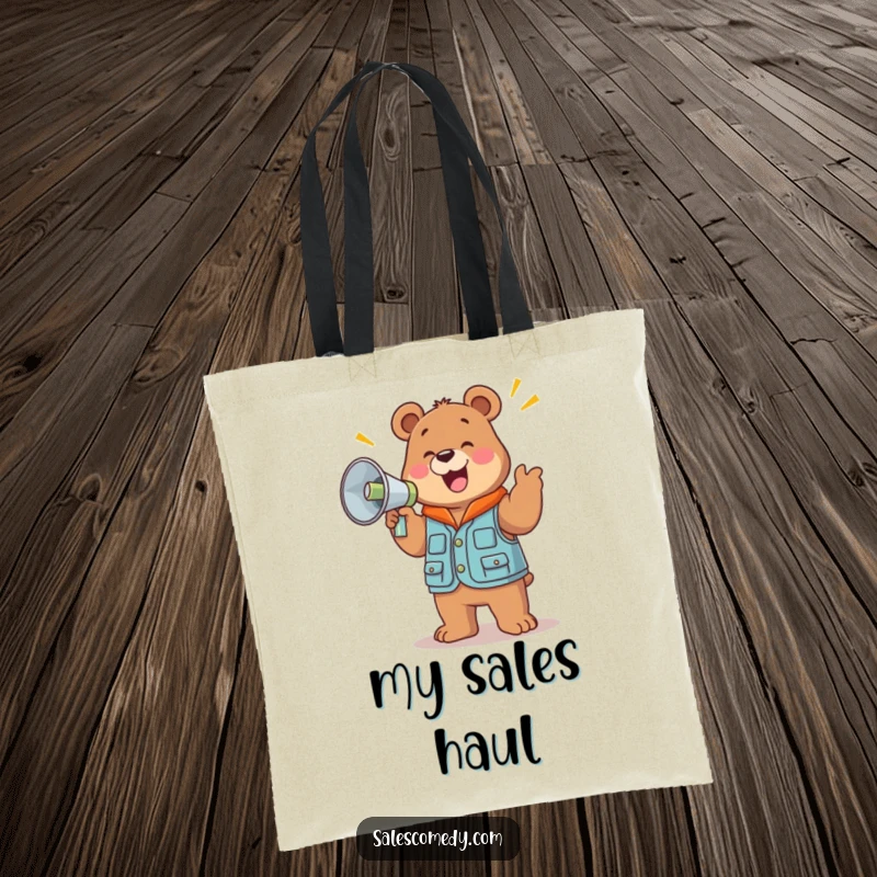 A funny, jolly bear in a sales vest holds a large megaphone and cheers, featured on this practical and humorous tote bag.